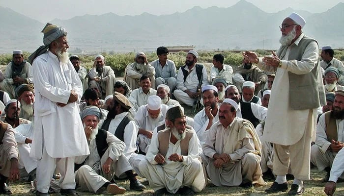 A representational image shows members of a Jirga sitting while an elder speaks. — AFP/File