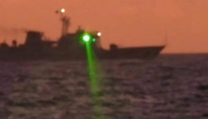 This image shows the apparent laser light being directed from a vessel. — AFP/File