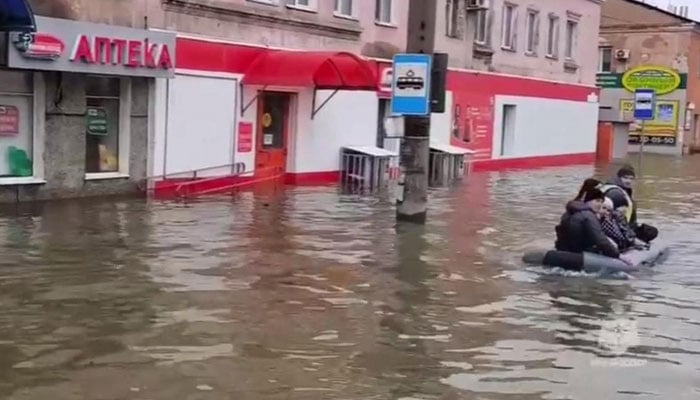 This photo taken from a video released by the Russian Emergency Situations Ministry on April 7, 2024 shows rescuers evacuating residents during a flood in the town of Orsk, Orenburg region. — AFP