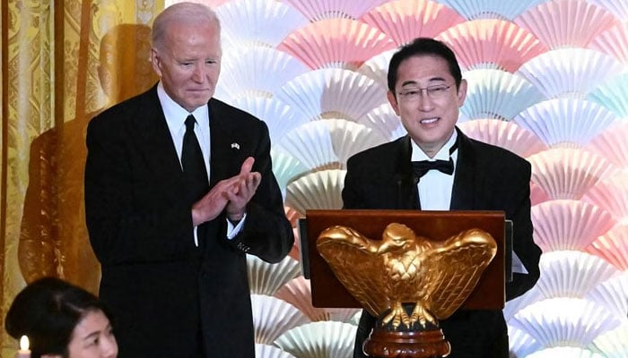 US President Joe Biden applauds as Japanese Prime Minister Fumio Kishida speaks during a state dinner in Washington. — AFP/File