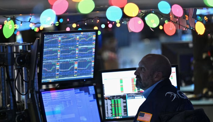 Traders at the New York Stock Exchange this month. The international economy has proved to be remarkably resilient this year, which provides strong foundations for 2024. — AFP/File