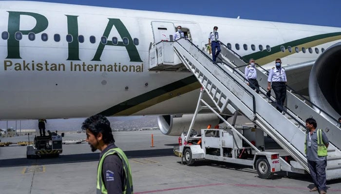 Crew members disembark from a Pakistan International Airways (PIA) flight at Kabul Airport, Afghanistan.— AFP/File