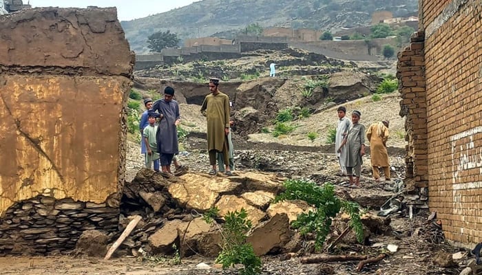 People stand near destruction after floods due to heavy monsoon rain in Landikotal. — PPI/File