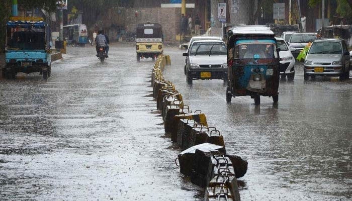 Vehicles passing through rainwater during the heavy rain in Karachi. — INP/File