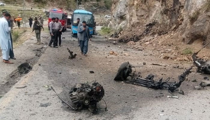 Vehicle parts can bee seen on the road in the aftermath of the deadly suicide attack on bus carrying Chinese engineers on March 26, 2024. — X/@WaliKhan_TK