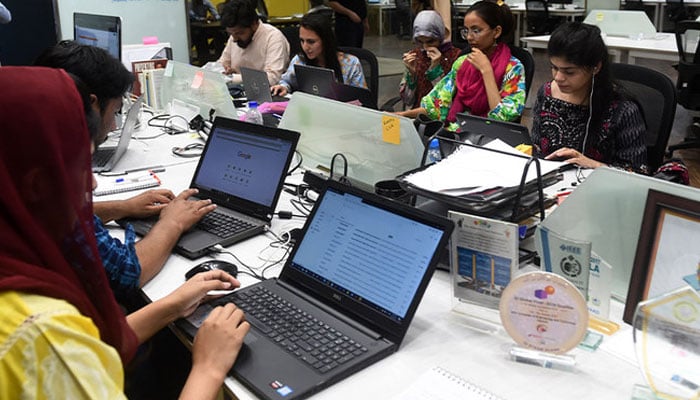 People work at their stations at the National Incubation Centre (NIC), a start-up incubator, in Lahore. — AFP/File