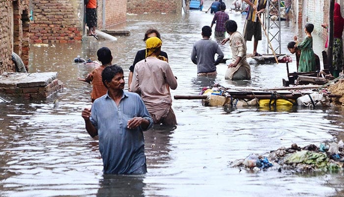 Rain affected people by flash floods after torrential rains hit Hyderabad. — APP/File