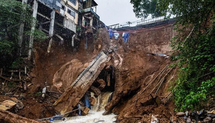 The foundation of a building on the edge of the ravine is seen following a landslide caused by heavy rains in the Caringin area, in Bogor on March 2, 2023. — AFP