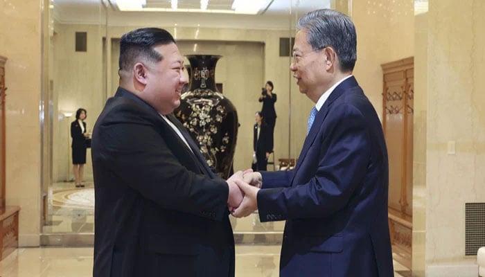 Zhao Leji (R), President of The National Peoples Congress of the Peoples Republic of China, shakes hands with Kim Jong Un, Supreme Leader of North Korea, in Pyongyang, DPRK, on April 13, 2024. — Xinhua