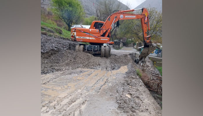 In this image district administrations machinery clearing roads blocked by the landslides and sludge left by the floods on April 14, 2024. — Facebook/Deputy Commissioner Lower Chitral