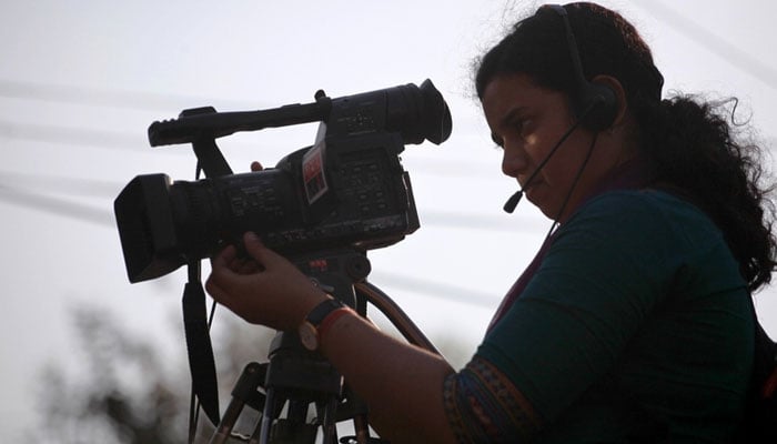 A representational image showing a woman operating a camera in Dhaka, Bangladesh. — IFEX/File