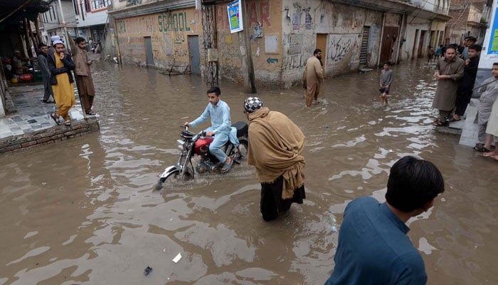 Commuters face difficulties in transportation due to stagnant rainwater in Peshawar on April 15, 2024. — PPI