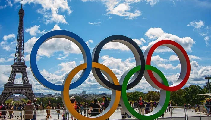 In this picture people standing in front of The Eiffel Tower — AFP/File