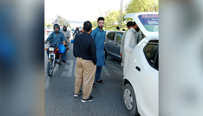 Excise and Taxation (E&T) Department personnel checking illegal modifications on vehicles in Islamabad on April 7, 2024. — Facebook/Office of the Deputy Commissioner, Islamabad