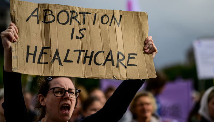 A pro-abortionist holds a protest card during a demonstration in Berlin. — AFP/File