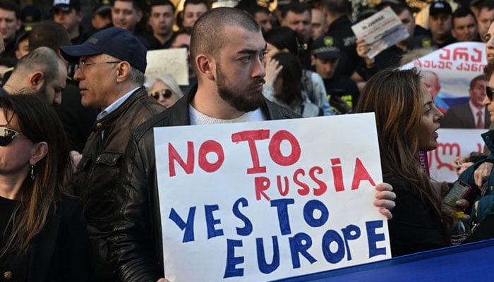 Georgian pro-democracy groups activists protest against a repressive foreign influence bill outside the parliament in Tbilisi on April 15, 2024. — AFP