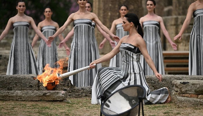 Greek actress Mary Mina, playing the role of the High Priestess, lights the torch during the flame lighting ceremony for the Paris 2024 Olympics Games on April 16, 2024. — AFP