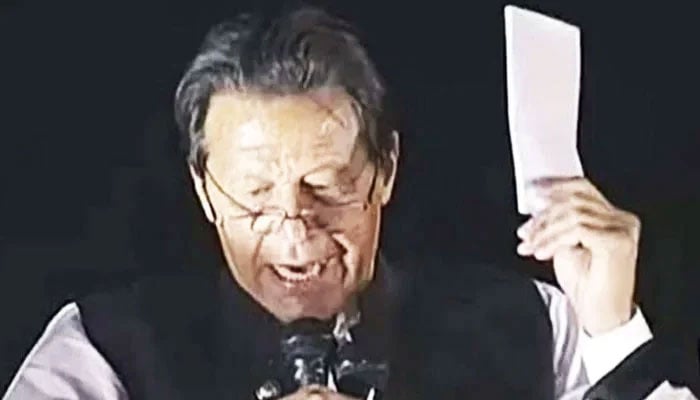 In this file photo, former PM Imran Khan holds what he said was a cipher which is proof of a “foreign conspiracy” to oust him from office during a rally in Islamabad. — X/@MuzamilChang/File