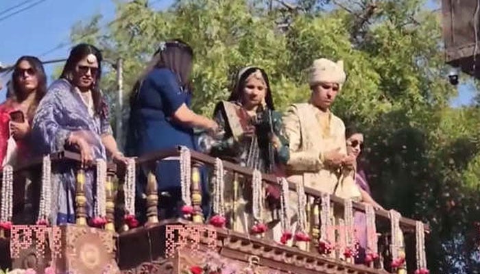 Gujarati businessman Bhavesh Bhandari and his wife stand a top a vehicle during their wedding procession. — Screengrab/PTI/File