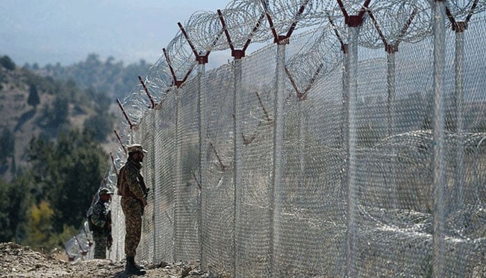 Pakistani soldiers keep vigil next to newly fenced border fencing along with Afghans Paktika province border in Angoor Adda in South Waziristan. — AFP/File