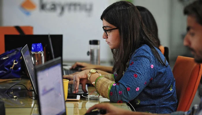 Pakistani employees of online marketplace company Kaymu at work in Karachi. — AFP/File