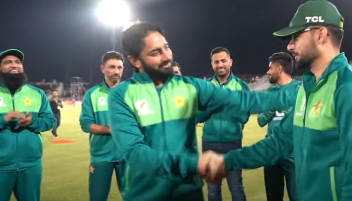 Screenshot shows spin wizard Saeed Ajmal handing over the cap to Ibrar. — YouTube/Pakistan Cricket