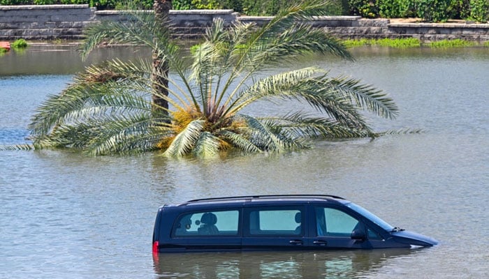 Cars are stranded on a flooded in Dubai following heavy rains on April 18, 2024. — AFP