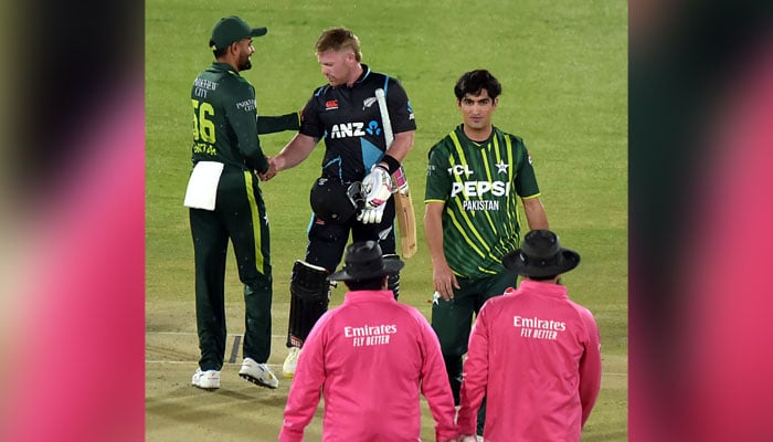 Pakistan captain Babar Azam shakes hands with New Zealand batsman after a cancelled match due to rain, at the Rawalpindi Cricket Stadium on April 18, 2024. — Online
