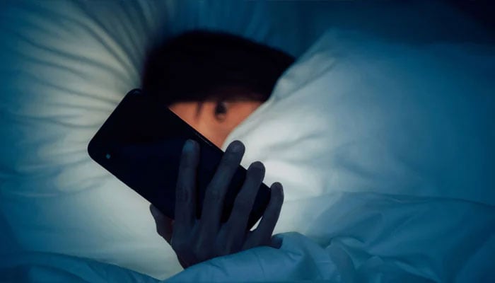 A person using a smartphone during night. — X/@malwarebyteslabs