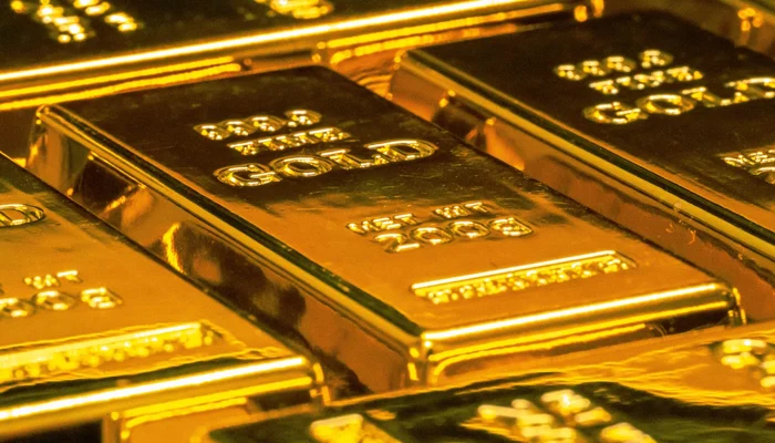 This representational image shows gold bars. — Unsplash