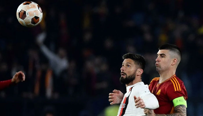 AC Milans French forward Olivier Giroud (L) fights for the ball with Romas Italian defender Gianluca Mancini during the UEFA Europa League football match between AS Roma and AC Milan at the Olympic stadium, in Rome on April 18, 2024. — AFP