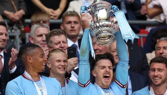 Manchester City Players celebrate with the Trophy. — AFP/File