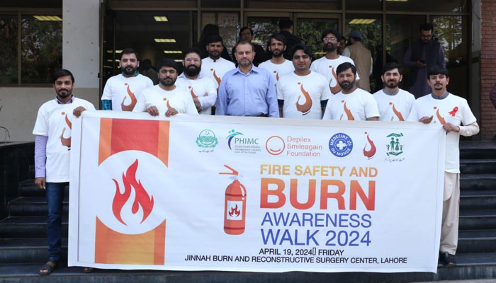 Participants hold a burn prevention walk and awareness banner at Jinnah Burn and Reconstructive Surgery Centre on April 19, 2024. — Facebook/Laforma Clinic - Dr. Farrukh Aslam
