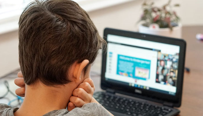 Representational image of a child taking an online class on his laptop. — Unsplash