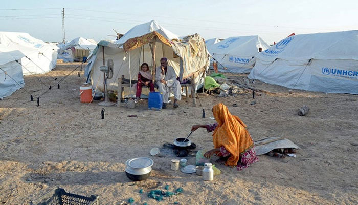 A woman cooks food for her family at a camp in Sohbatpur, Jaffarabad district of Pakistans Balochistan province. — AFP/ File