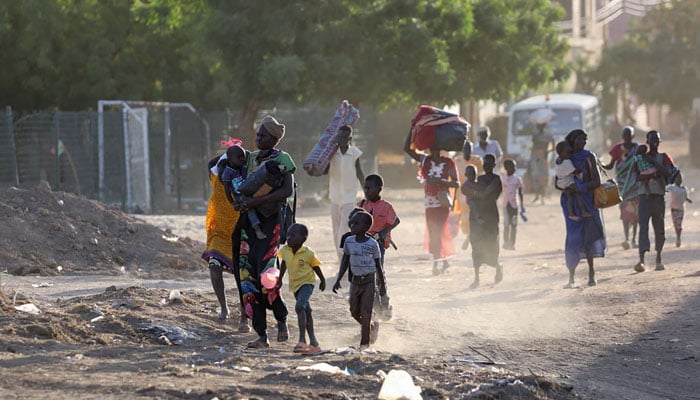 People flee their neighbourhoods amid fighting between the army and paramilitaries in Khartoum, Sudan. — AFP/File