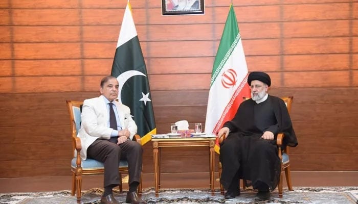 Prime Minister Shehbaz Sharif (L) meets Iran’s President Seyed Ebrahim Raisi. — PM Office/File