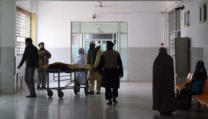 A representational image shows Pakistani relatives turning to a man treated at a hospital in Peshawar. —AFP/File