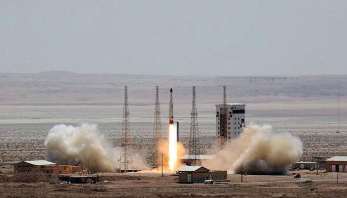 A handout picture released by Irans Defence Ministry shows a Simorgh (Phoenix) satellite rocket at its launch site at an undisclosed location in Iran. —  AFP/File