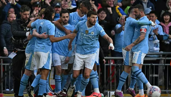 Manchester Citys Portuguese midfielder Bernardo Silva (3L) celebrates with teammates after scoring the opening goal of the English FA Cup semi-final football match between Manchester City and Chelsea. — AFP/File