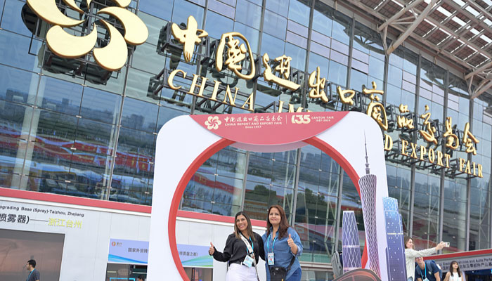 Participants pose for a picture in front of the venue for the 135th China Import and Export Fair, or Canton Fair, in Guangzhou City, South Chinas Guangdong Province, on April 15, 2024. — CFP