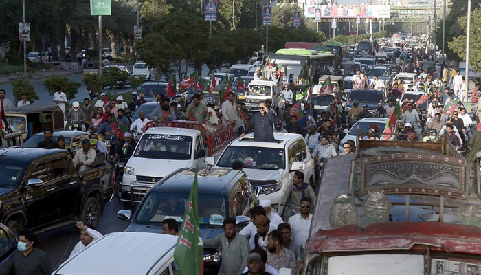 Leaders and members of Tehreek-e-Insaf (PTI) holding a protest demonstration for release of PTI founder Imran Khan, at Shahrah-e-Faisal Road in Karachi on  April 21, 2024. — PPI