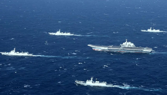 A Chinese navy formation, including the aircraft carrier Liaoning, during military drills in the South China Sea. — AFP/File