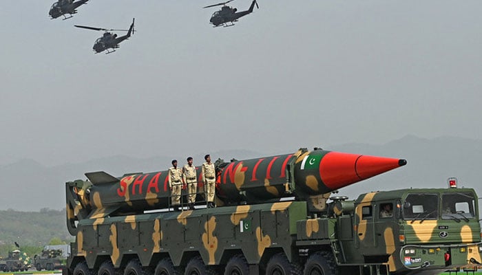 Pakistani military helicopters fly past a vehicle carrying a long-range ballistic Shaheen III missile during the military parade to mark Pakistans National Day in Islamabad. — AFP/File