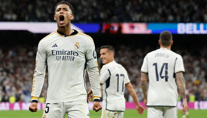 Real Madrids English midfielder Jude Bellingham rejoicing after scoring his teams third goal during the Spanish league football match against FC Barcelona at the Santiago Bernabeu stadium in Madrid on Sunday — AFP