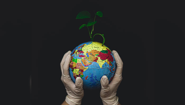 A representational image of a person holding a globe to represent earth day. — Unsplash/File