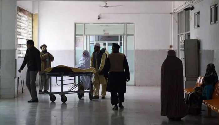 A representational image shows Pakistani relatives turning to a man treated at a hospital. —AFP/File