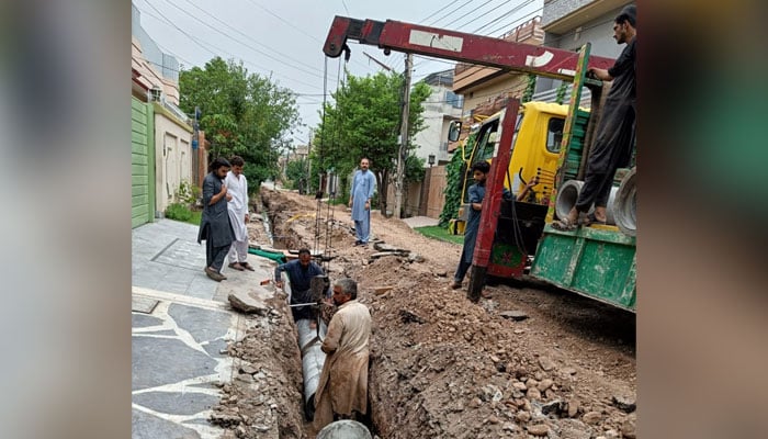 In this image labourer laying a sewerage line in Peshawar. — Facebook/Peshawar Development Authority/File