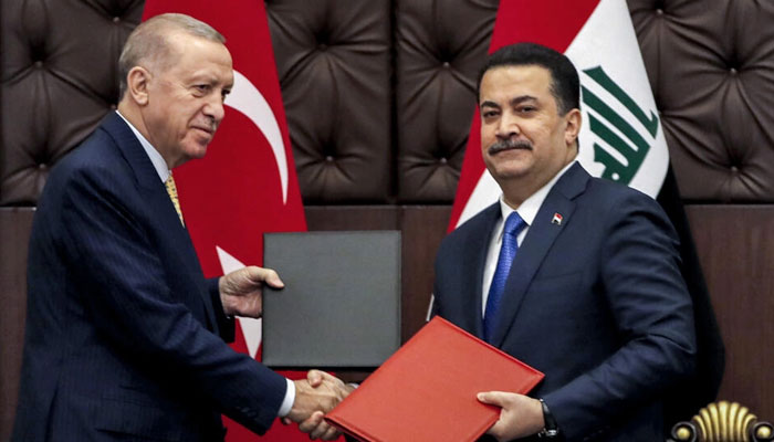 Turkeys President Recep Tayyip Erdogan and Iraqs Prime Minister Mohammed Shia al-Sudani exchange signed agreements. — AFP