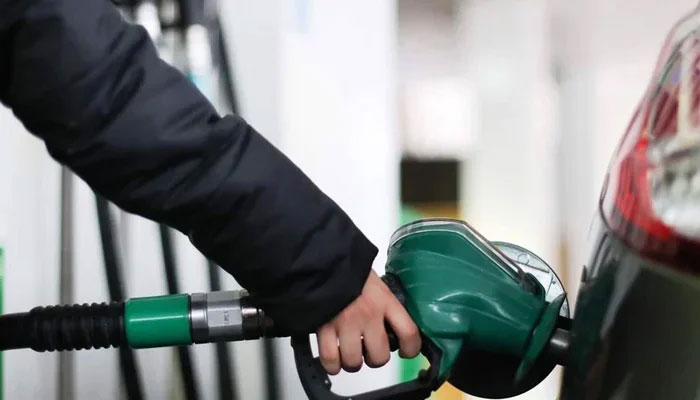 A person fills their cars tank at a fuel station in this undated file image. — AFP/File